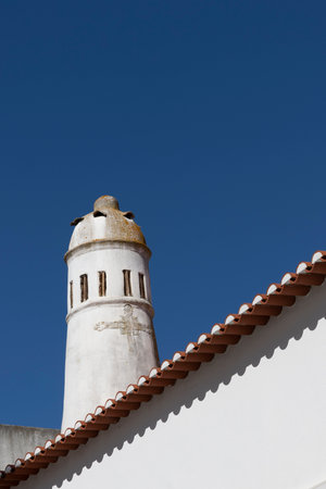 Traditional Portuguese chimney over a blue sky.の写真素材