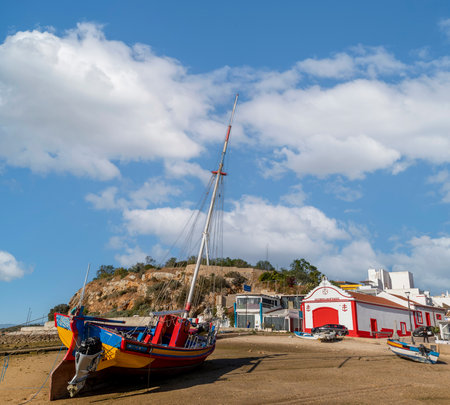 ALVOR, PORTUGAL - 16th APRIL, 2023: Beautiful traditional fishing boat and restored lifeguard station. at the town of Alvor.のeditorial素材