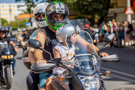 FARO, PORTUGAL - 24th JULY, 2023: Parade of several motorcyclists on the road for the 41st International Motorcycle Festival as a goodbye for the next year. There are nationalities from all over the world that participate and is considered one of the bestのeditorial素材