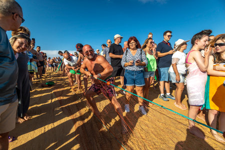 QUARTEIRA, PORTUGAL - 6th JUNE 2023: Cast net fishing tradition done by the local population at beach seashore.のeditorial素材