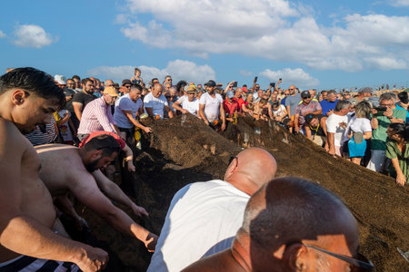 QUARTEIRA, PORTUGAL - 6th JUNE 2023: Cast net fishing tradition done by the local population at beach seashore.のeditorial素材
