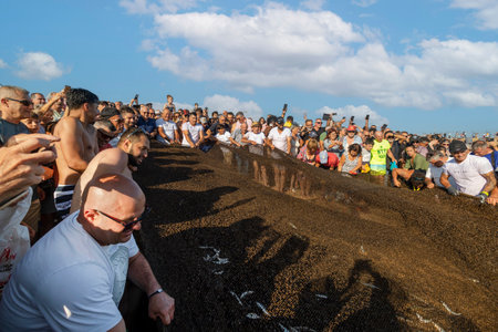 QUARTEIRA, PORTUGAL - 6th JUNE 2023: Cast net fishing tradition done by the local population at beach seashore.のeditorial素材