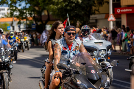 FARO, PORTUGAL - 24th JULY, 2023: Parade of several motorcyclists on the road for the 41st International Motorcycle Festival as a goodbye for the next year. There are nationalities from all over the world that participate and is considered one of the bestのeditorial素材
