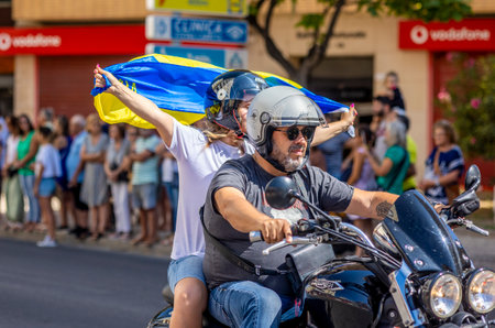 FARO, PORTUGAL - 24th JULY, 2023: Parade of several motorcyclists on the road for the 41st International Motorcycle Festival as a goodbye for the next year. There are nationalities from all over the world that participate and is considered one of the bestのeditorial素材