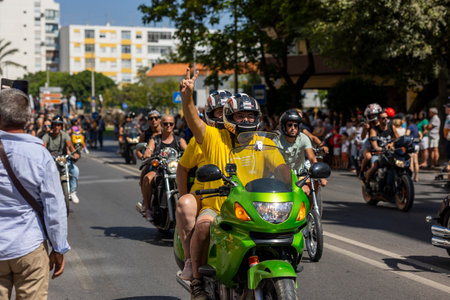 FARO, PORTUGAL - 24th JULY, 2023: Parade of several motorcyclists on the road for the 41st International Motorcycle Festival as a goodbye for the next year. There are nationalities from all over the world that participate and is considered one of the bestのeditorial素材
