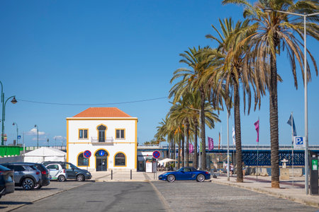 Downtown area of Portimao city with palm trees and the old fish market.