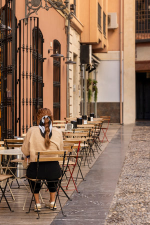 Woman relaxing on coffee shop in the morning, Malaga, Spain.の写真素材