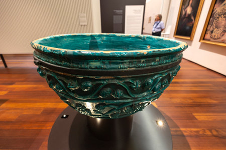 Malaga, Spain - October 21, 2023: Large baptismal font green ceramic bowl on Malaga museum, Spain.のeditorial素材