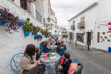 Mijas, Spain - October 22, 2023: Tourists enjoying their breakfast in the cute, beautiful and charming white village of Mijas, located in Andalusia. Spainのeditorial素材