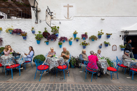 Mijas, Spain - October 22, 2023: Tourists enjoying their breakfast in the cute, beautiful and charming white village of Mijas, located in Andalusia. Spainのeditorial素材