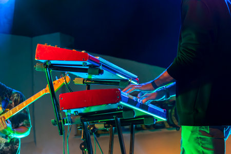 Close view of an Electronic keyboard music synthesizer player, playing on a live concert.の写真素材