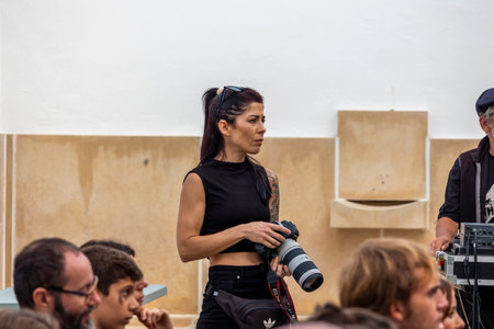 FARO, PORTUGAL: 7th SEPTEMBER, 2023 - Professional photographer taking photos in a live music concert at Festival F, a big festival in the city of Faro, Portugal.のeditorial素材