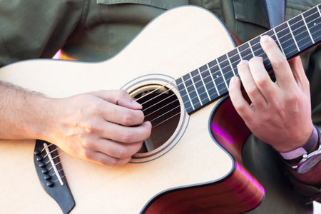 View of a Portuguese classical guitar playing on a music concert.