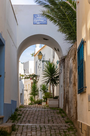 A sunny day on the Albufeira city downtown featuring a typical narrow street.の写真素材