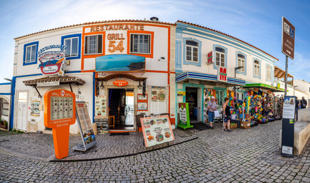 ALBUFEIRA, PORTUGAL - 9th NOVEMBER 2024: A sunny day on the Albufeira city downtown featuring businesses and typical narrow streets.のeditorial素材