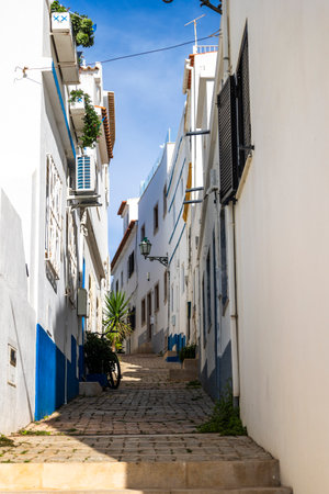 A sunny day on the Albufeira city downtown featuring a typical narrow street.の写真素材