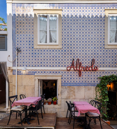 ALBUFEIRA, PORTUGAL - 9th NOVEMBER 2024: A sunny day on the Albufeira city downtown featuring businesses and typical narrow streets.のeditorial素材