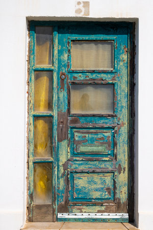 Close up view of an old rusted green wooden door.の写真素材