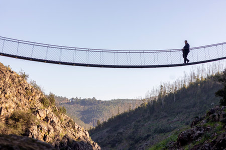 ALFERCE, PORTUGAL - 3rd FEBRUARY 2024: Wooden path, suspended bridge in the mountain used by many hiking tourists, located in Alferce, Monchique, Portugal.のeditorial素材