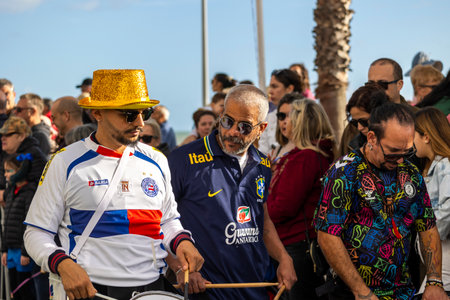 QUARTEIRA, PORTUGAL - 13th FEB 2024: Colorful Carnival (Carnaval) Parade festival audience participants on Quarteira city, Portugal.のeditorial素材