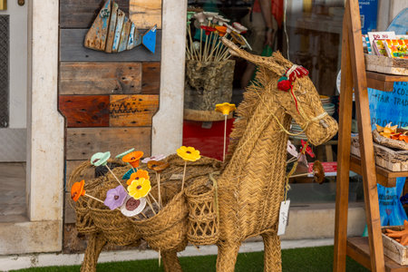 Wicker donkey art on a Portuguese store that sells souvenirs for tourists.の写真素材