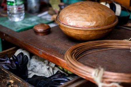 Workbench of a copper worker artisan who makes all kinds of home utensils with brass and copper.