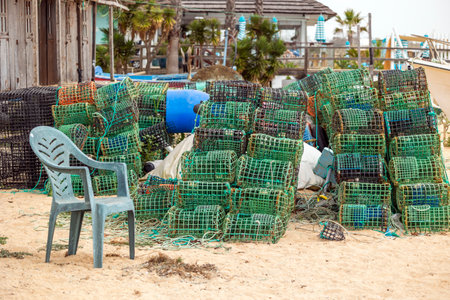Close up view of many crab and lobster traps equipment on a beach of the Algarve region.の写真素材