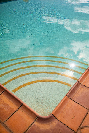 Detailed view of the stairs in a clear water swimming pool.の写真素材