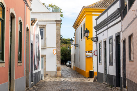 Cobblestone street and historical house in Faro city, Algarve, Portugal.の写真素材