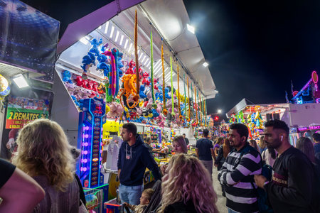 FARO, PORTUGAL - 20th OCOTOBER 2024: Fun fair luck game with toys at night in the city of Faro, Portugal.の写真素材