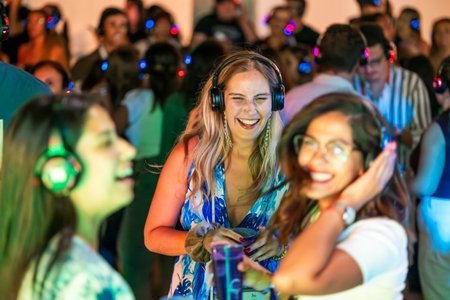 FARO, PORTUGAL: 5th SEPTEMBER, 2024 - Audience enjoying music in headphones on Festival F, a silent disco concept.のeditorial素材