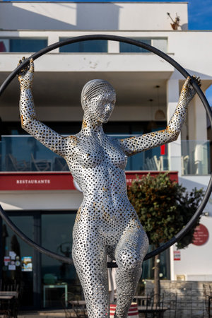 ARMACAO DE PERA, PORTUGAL - 9th NOVEMBER 2024: Metal tubes sculpture of a sensual woman posing in Armacao de Pera, Portugal.のeditorial素材