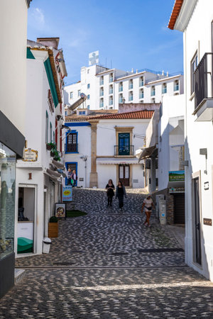 ALBUFEIRA, PORTUGAL - 9th NOVEMBER 2024: Albufeira city downtown businesses with tourists having a good time in the bars and restaurants.のeditorial素材