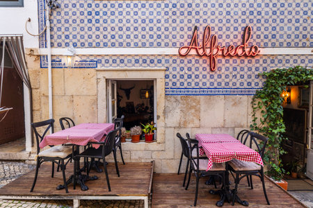ALBUFEIRA, PORTUGAL - 9th NOVEMBER 2024: A sunny day on the Albufeira city downtown featuring businesses and typical narrow streets.のeditorial素材