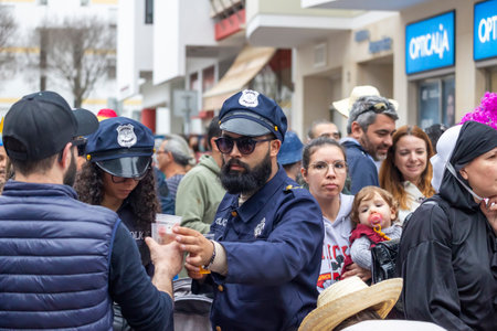 LOULE, PORTUGAL - 17th FEB 2024: Colorful Carnival (Carnaval) Parade festival audience participants on Loule city, Portugal.のeditorial素材