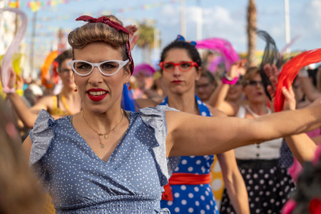 QUARTEIRA, PORTUGAL - 13th FEB 2024: Colorful Carnival (Carnaval) Parade festival participants on Quarteira city, Portugal.のeditorial素材