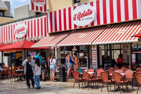 ALBUFEIRA, PORTUGAL - 7th MAY 2024: Albufeira city downtown businesses with people walking around.のeditorial素材