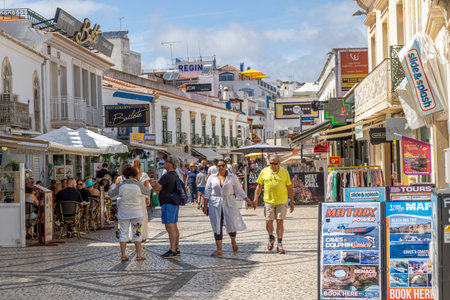 ALBUFEIRA, PORTUGAL - 7th MAY 2024: Albufeira city downtown businesses with tourists having a good time in the bars and restaurants.のeditorial素材