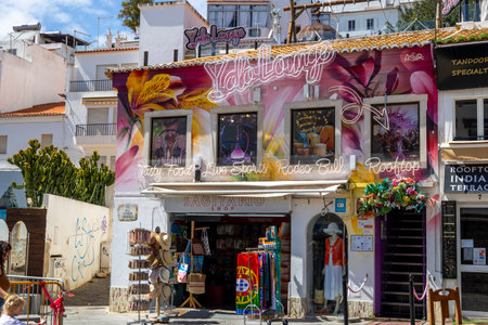 ALBUFEIRA, PORTUGAL - 7th MAY 2024: Albufeira city downtown businesses with tourists having a good time in the bars and restaurants.のeditorial素材