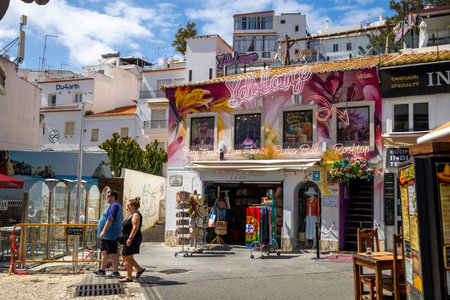 ALBUFEIRA, PORTUGAL - 7th MAY 2024: Albufeira city downtown businesses with tourists having a good time in the bars and restaurants.のeditorial素材