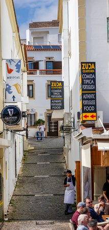 ALBUFEIRA, PORTUGAL - 7th MAY 2024: Albufeira city downtown businesses with tourists having a good time in the bars and restaurants.のeditorial素材