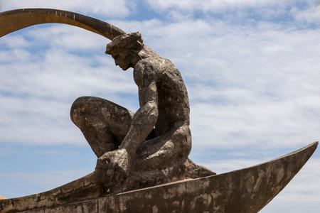 Statue of a fisherman throwing the net artwork in a roundabout in Albufeira city, Algarve - Portugal.の写真素材