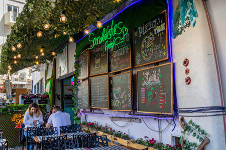 ALBUFEIRA, PORTUGAL - 7th MAY 2024: Albufeira city downtown businesses with tourists having a good time in the bars and restaurants.のeditorial素材