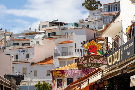 ALBUFEIRA, PORTUGAL - 7th MAY 2024: Albufeira city downtown businesses with tourists having a good time in the bars and restaurants.のeditorial素材