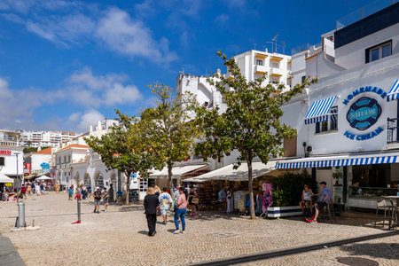 ALBUFEIRA, PORTUGAL - 7th MAY 2024: Albufeira city downtown businesses with tourists having a good time in the bars and restaurants.のeditorial素材
