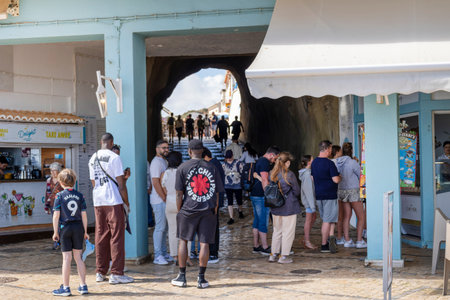 ALBUFEIRA, PORTUGAL - 7th MAY 2024: Albufeira city downtown businesses with people walking around.のeditorial素材