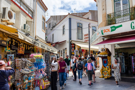 ALBUFEIRA, PORTUGAL - 7th MAY 2024: Albufeira city downtown businesses with tourists having a good time in the bars and restaurants.のeditorial素材