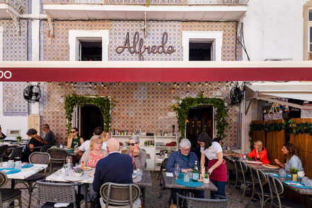 ALBUFEIRA, PORTUGAL - 7th MAY 2024: Albufeira city downtown businesses with tourists having a good time in the bars and restaurants.のeditorial素材