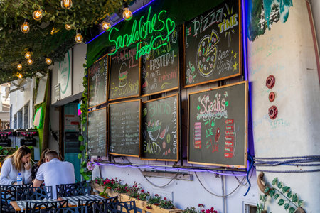 ALBUFEIRA, PORTUGAL - 7th MAY 2024: Albufeira city downtown businesses with tourists having a good time in the bars and restaurants.のeditorial素材