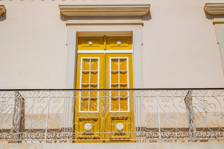 Beautiful yellow Portuguese window located in the city of Albufeira, Portugal.の写真素材